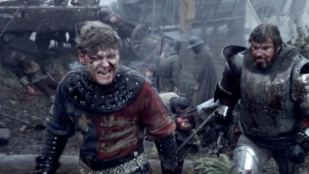 A scene from Kenneth Branagh's "Henry V" where a battered and enraged King Henry shouts "I was not angry since I came to France...." while Exeter storms behind him in full battle armor. 