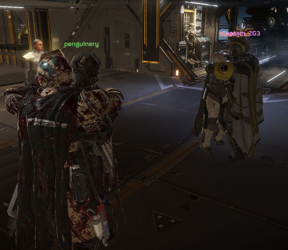 Helldivers 2 gameplay. Four players on the pre-mission ship hugging each-other.