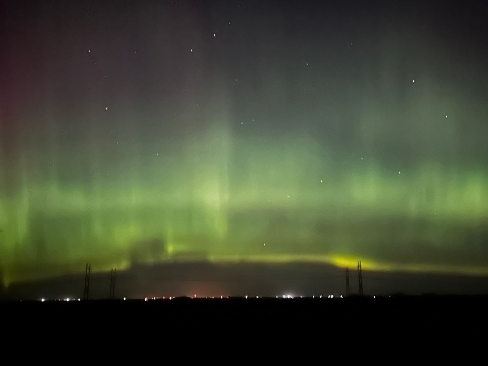 Mostly horizontal greenish glow in the night sky