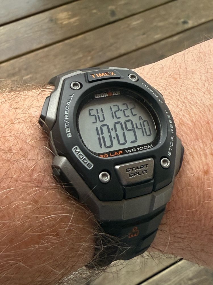A Timex Ironman digital wrist watch on a wrist. 
