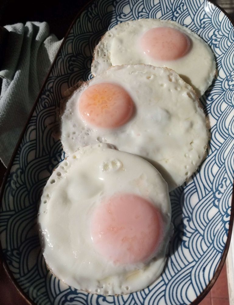 3 Phenomenally Cooked eggs on a ceramic plate