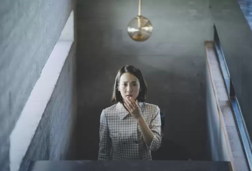 a woman covering her mouth in shock and horror