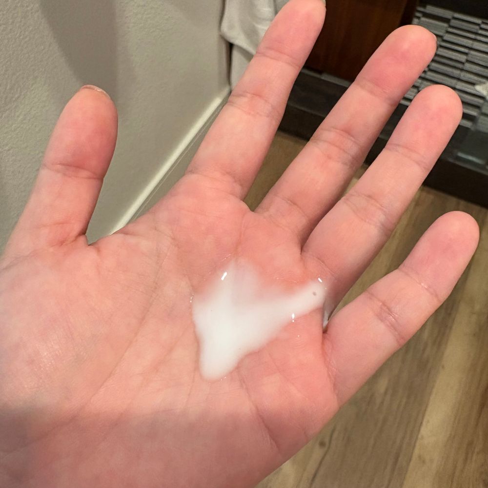 Some white skincare product in a palm that looks suspiciously like friggen cum