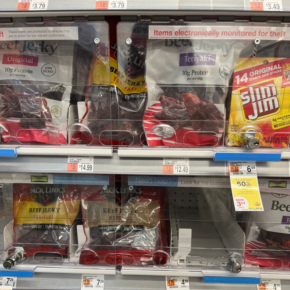 A bunch of shitty beef jerky behind security barriers at a drug store