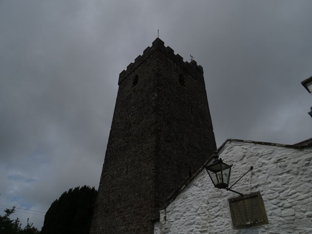 Medieval church tower with grey sky