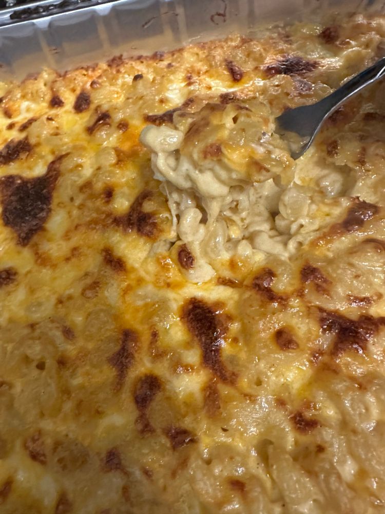 Showing cheese pull of Mac and cheese 