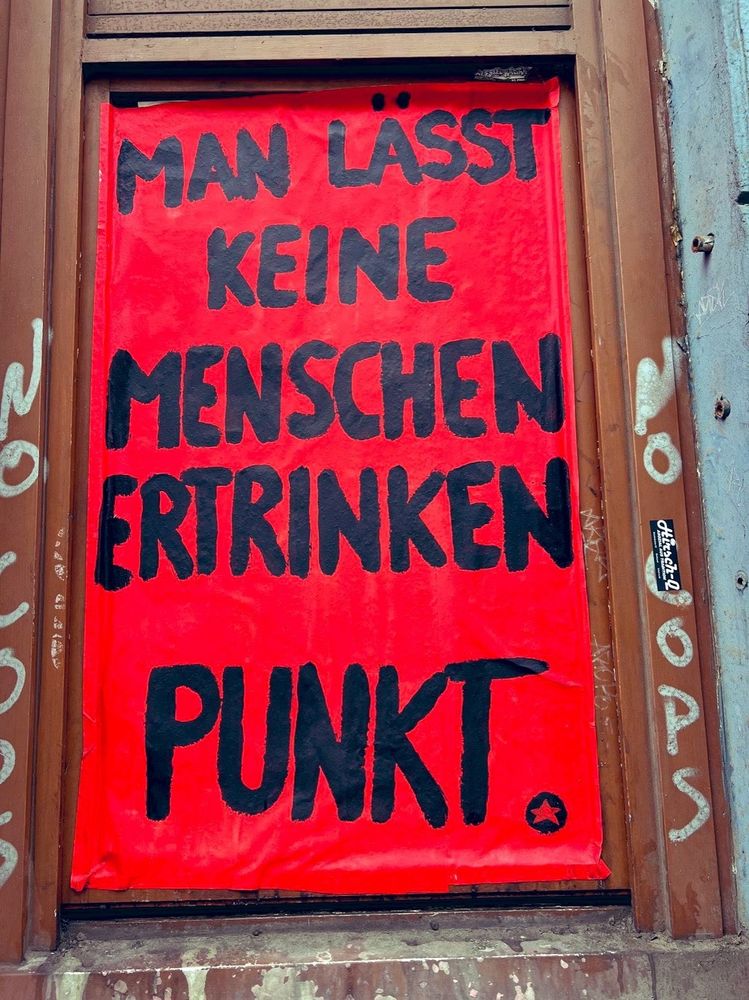 Auf einem Fensterrahmen steht "man lässt keine Menschen ertrinken. Punkt."