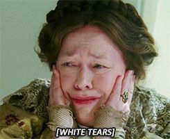 Kathy Bates clutches her face in distress. The caption reads “white tears”