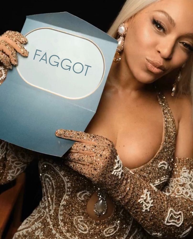 Beyoncé holds open an awards show envelope, which has been photoshopped to say “FAGGOT”