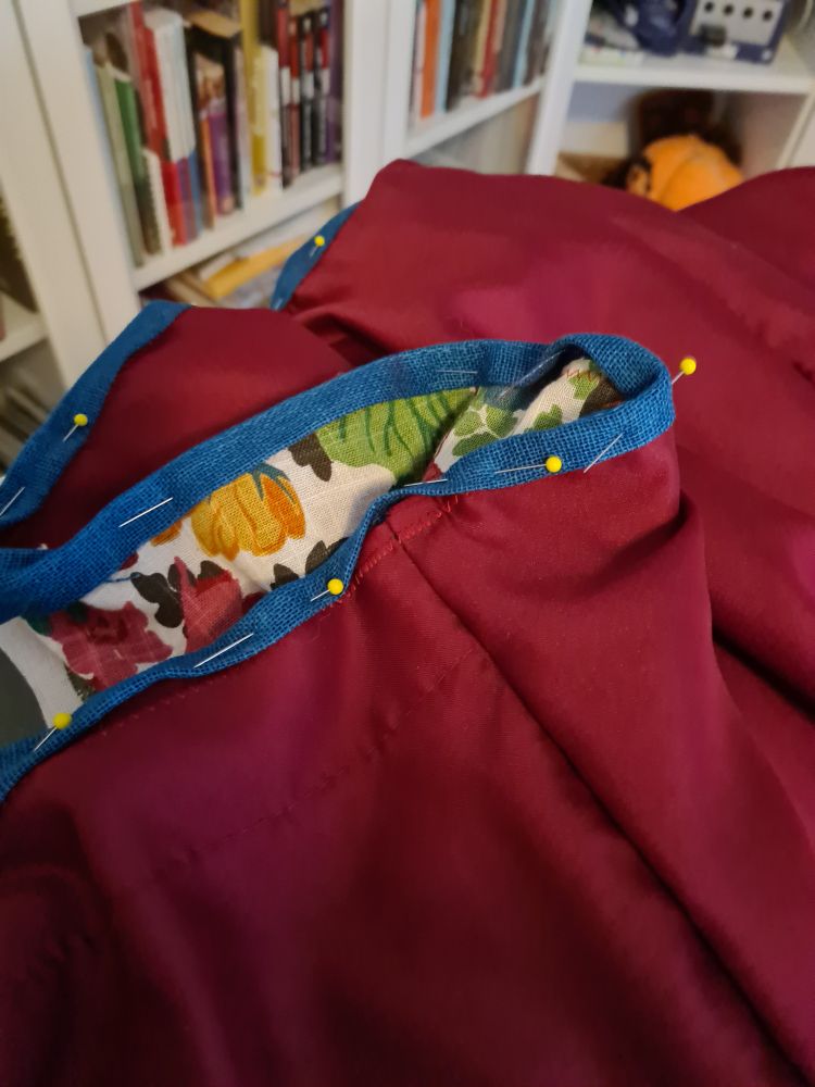 Photo of a sewing project in process, with multiple pins in it.