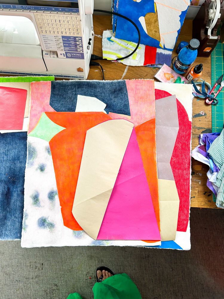 Stack of geometric colorful drawings on studio desk. 