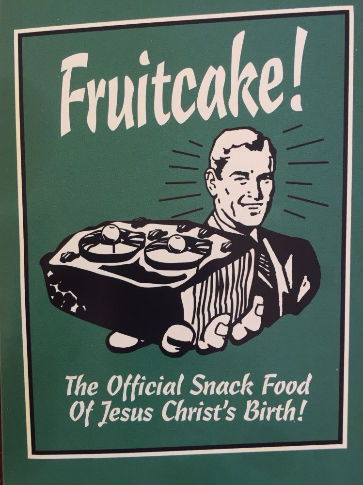 Greeting card, 50s guy in a suit holding a fruitcake. “Fruitcake! The official snack food of Jesus Christ’s Birth!”