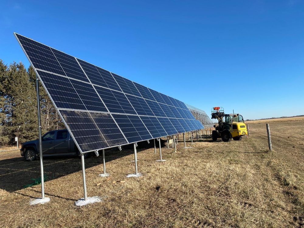Photo of a solar array construction with a wheel loader in the foreground