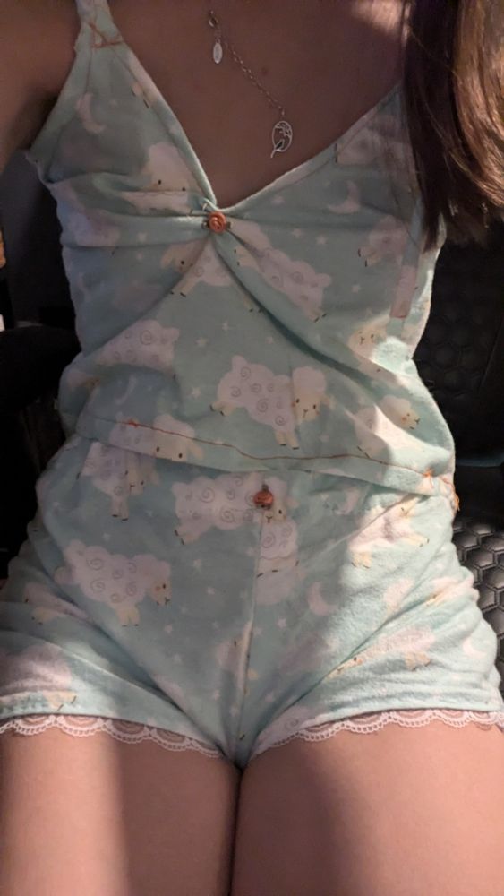 Sheep print shorts with lace at the legs and a flower on the middle top and a sheep print tank top that's cinched in the middle chest and has a rose over the cinched fabric