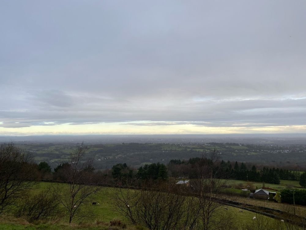 A view of the Cheshire Plain in winter. Cloudy skies but with a hint of brightness on the horizon. 
