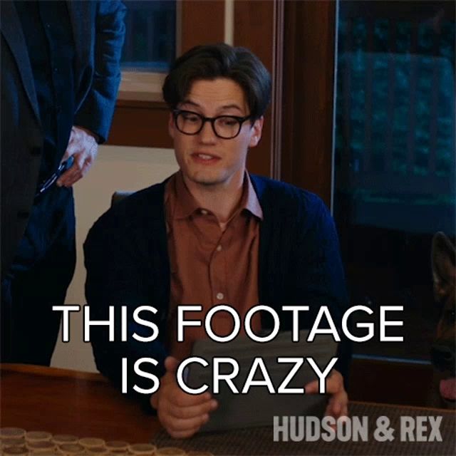 a man sitting at a table with the words this footage is crazy hudson & rex