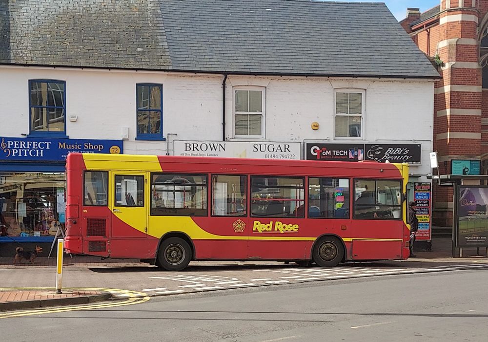 Red and yellow singe deck bus operated by Red Rose Travel parked in Chesham Broadway.