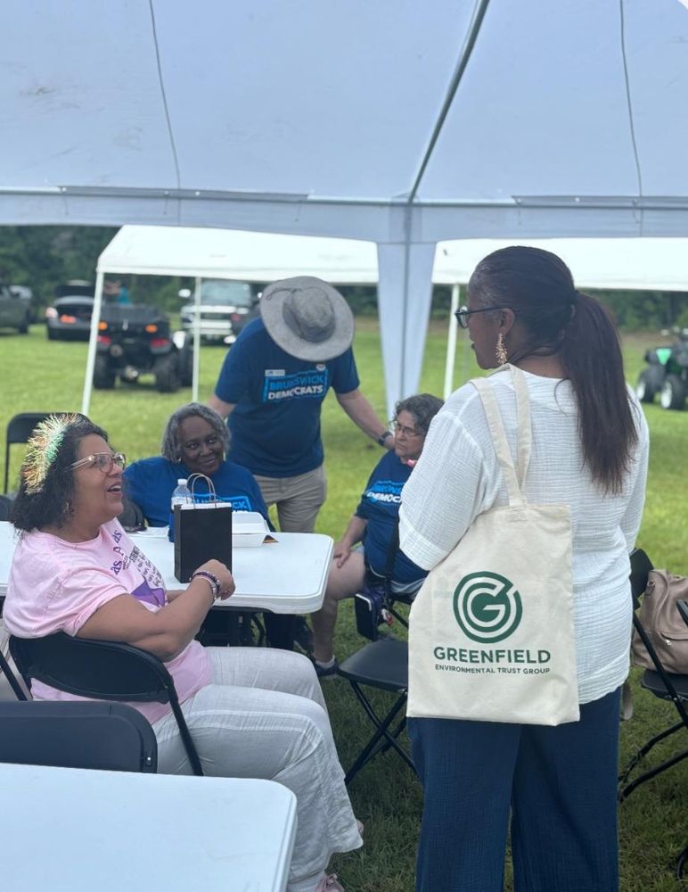 Picture of Kimberly Hardy talking with two people at an outdoor event.