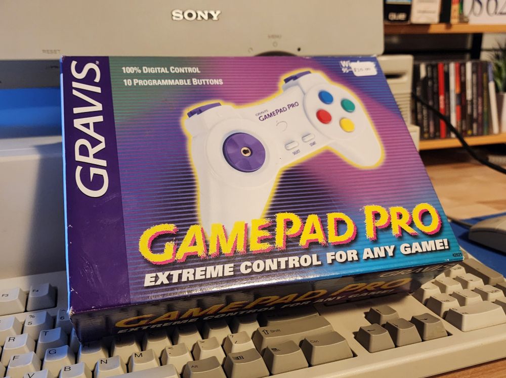 A boxed gravis gamepad pro sits on a keyboard