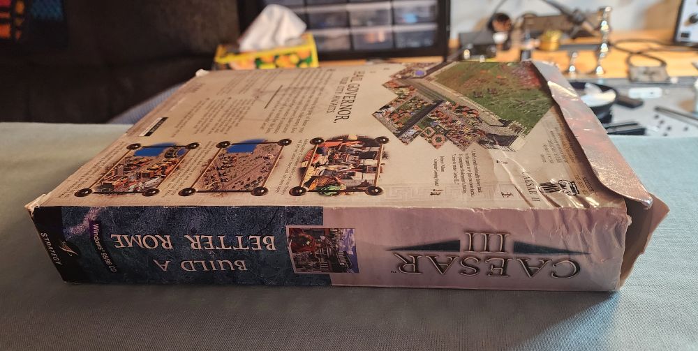 The box for the pc game Caesar 3, that has been slightly crushed. Picture of before ironing