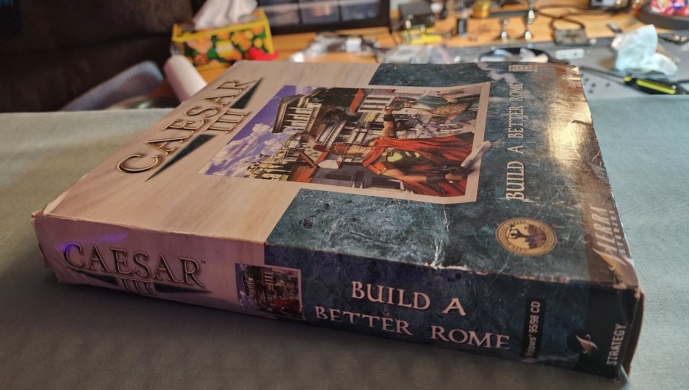 The box for the pc game Caesar 3, that has been slightly crushed. Picture of before ironing