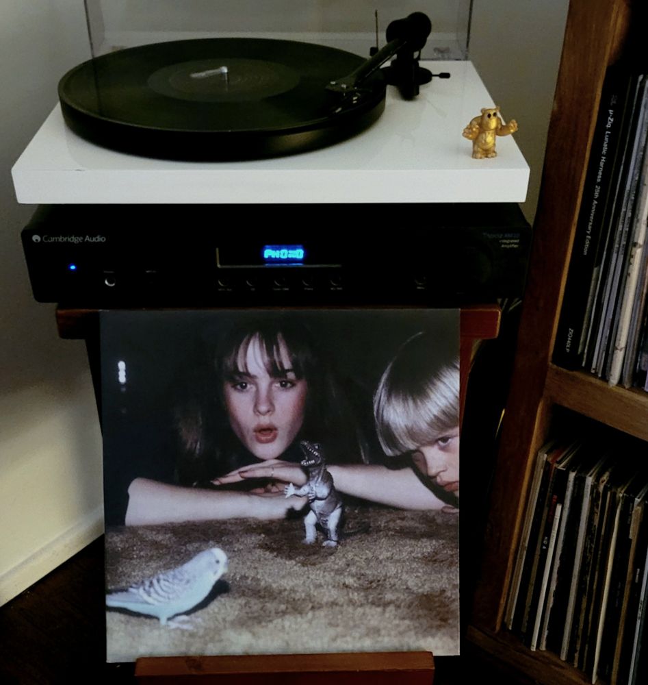 Vinyl record on turntable, cover displayed. 
Artist: Big Thief
Album: Masterpiece 