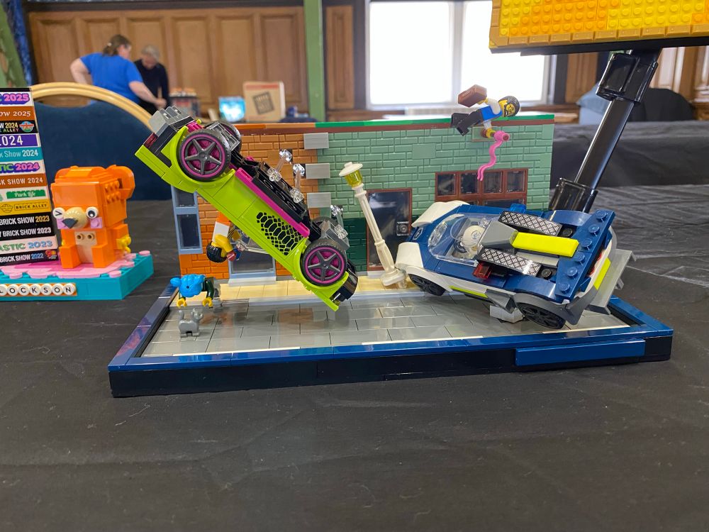 Cat in Road. A diorama depicting a car accident caused by a cat standing in the road.