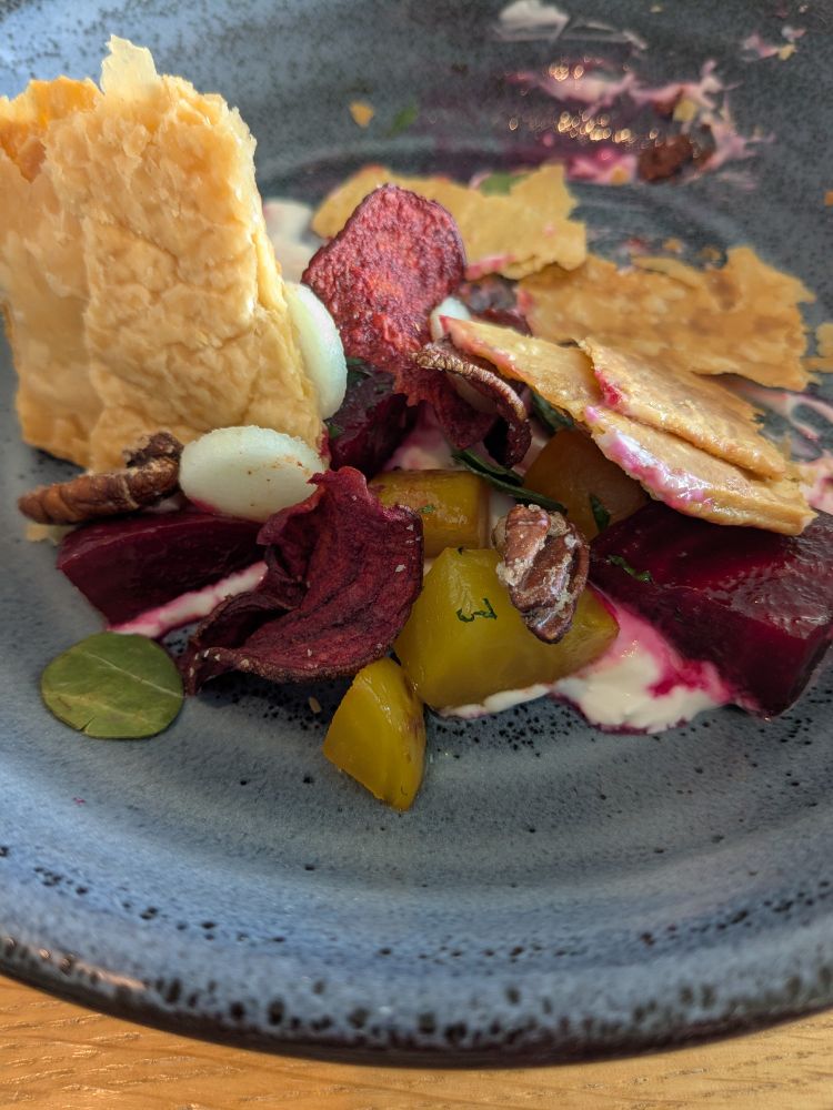 Honey roasted beets with candied pecans and puff pastry pieces.