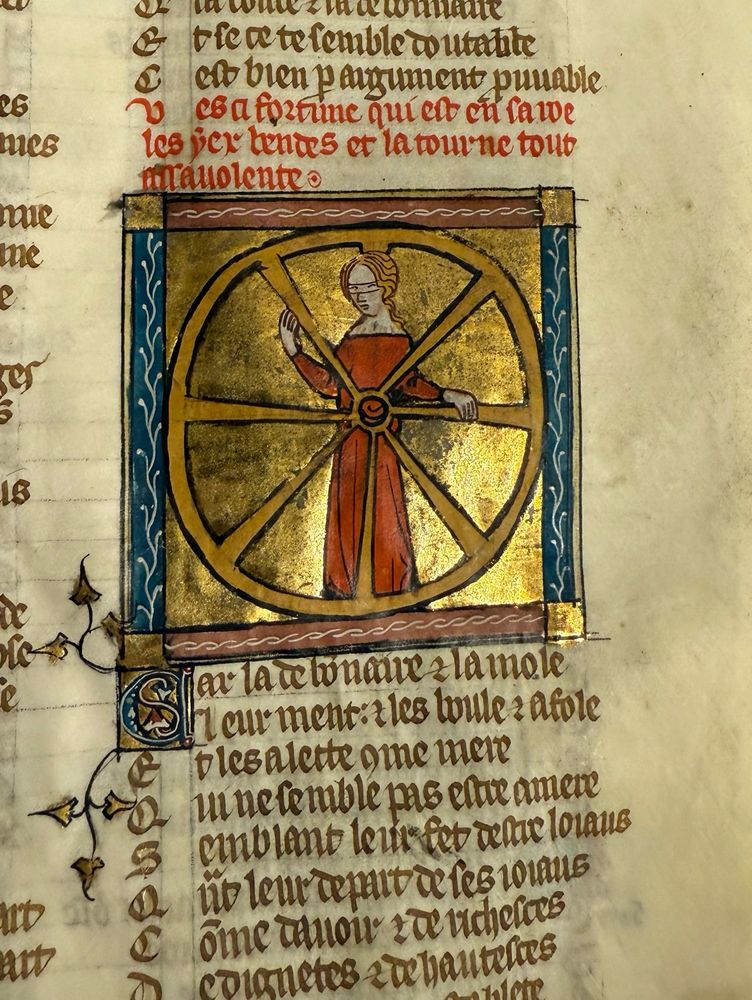 A personification of fortune as a blind woman turns her wheel. From a Roman de la Rose manuscript made in Paris, circa 1340.
