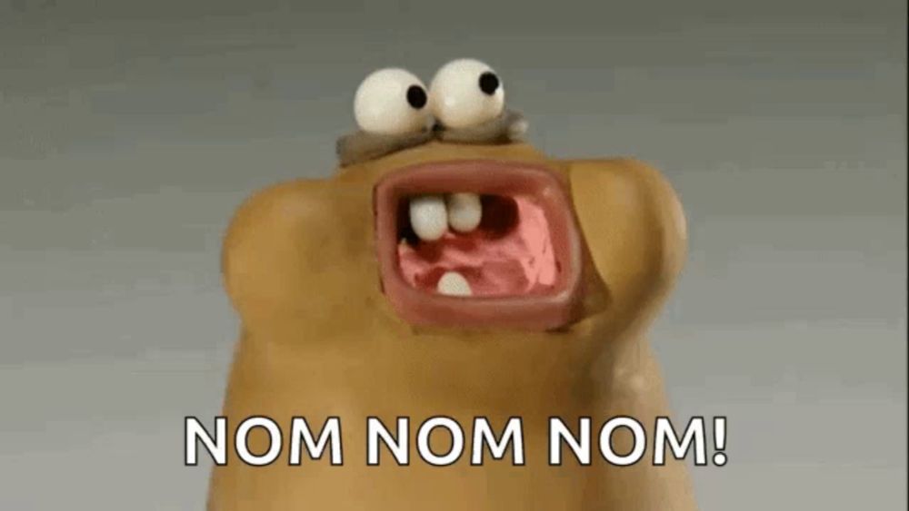 a cartoon character with its mouth open and the words nom nom nom below it