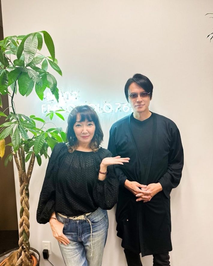 portrait of Mayumi Chiwaki standing and posing next to Atsushi Sakurai of BUCK-TICK 