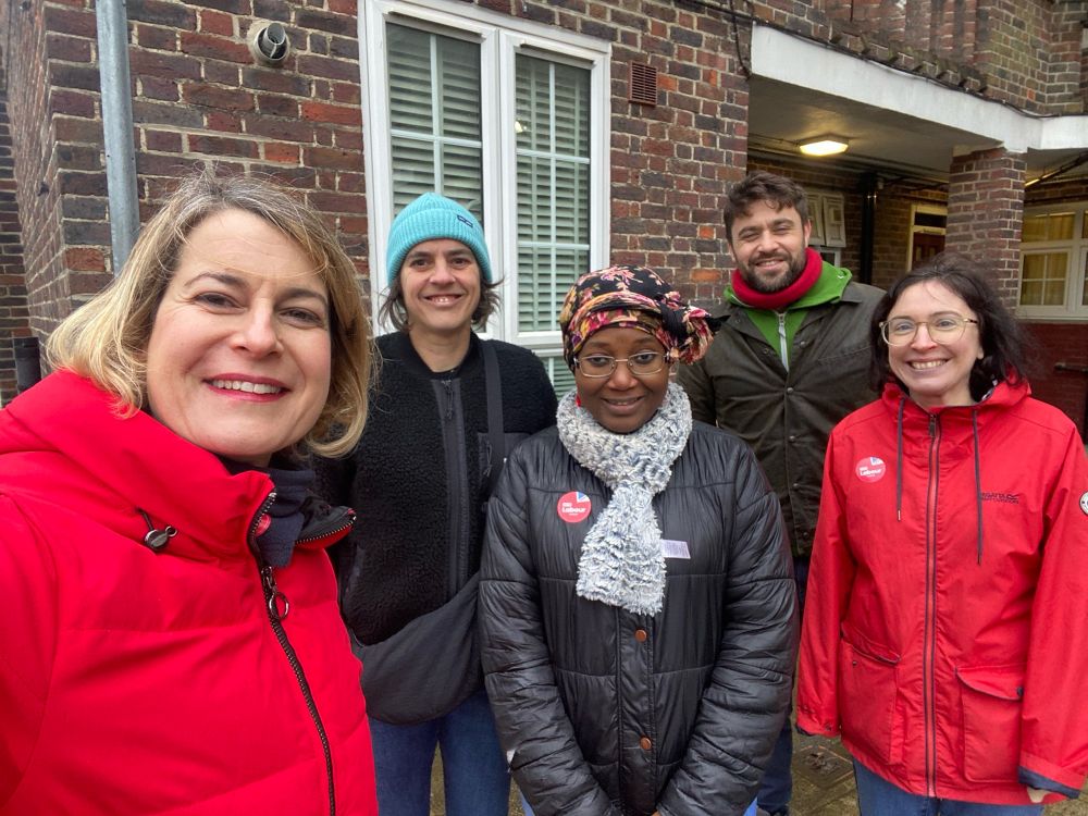 Labour campaigners smiling in the rain