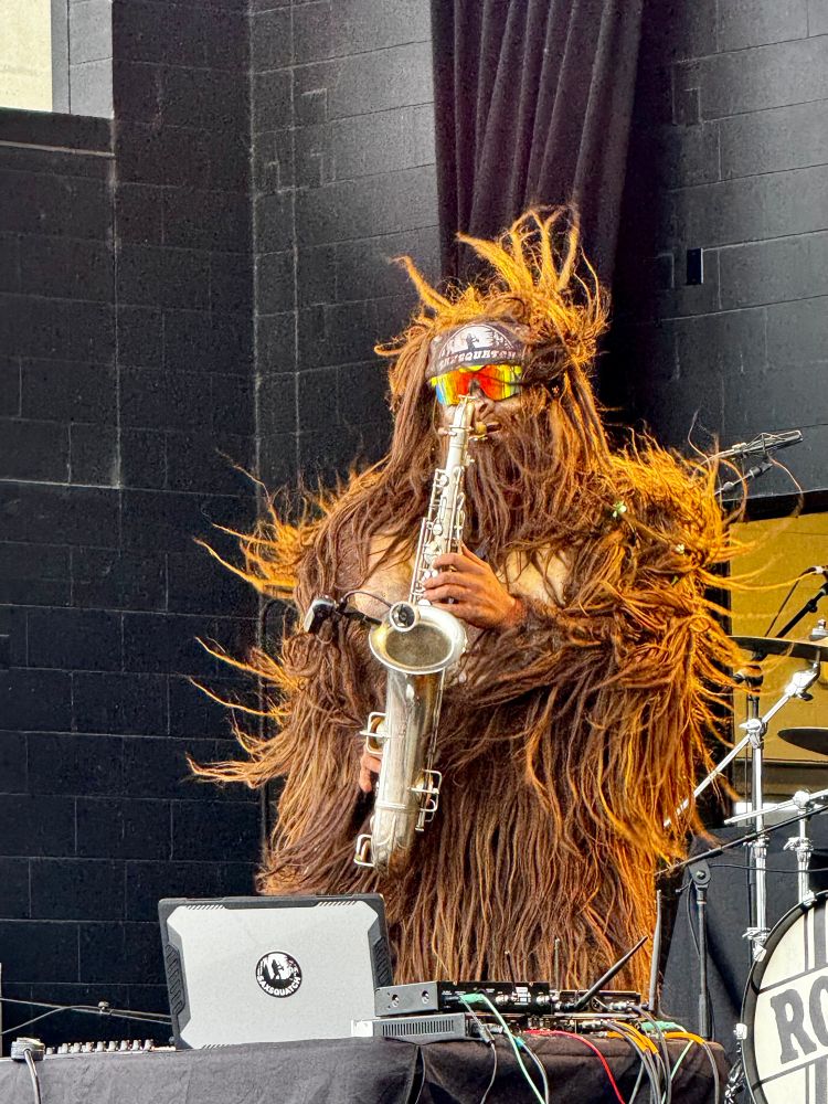 Photo of a Sasquatch wearing sunglasses and playing saxophone 