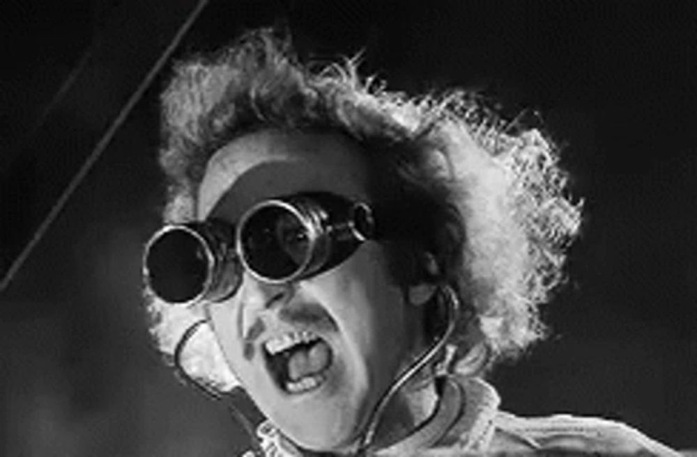 a black and white photo of a man wearing a pair of goggles .