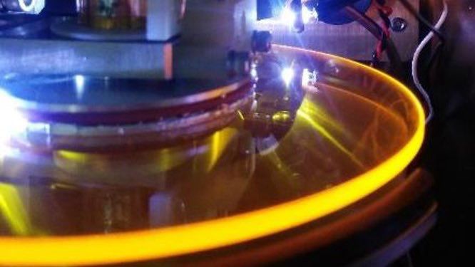 ZnSe (yellow glass) CD sized disc inside vacuum chamber illuminated by LEDs