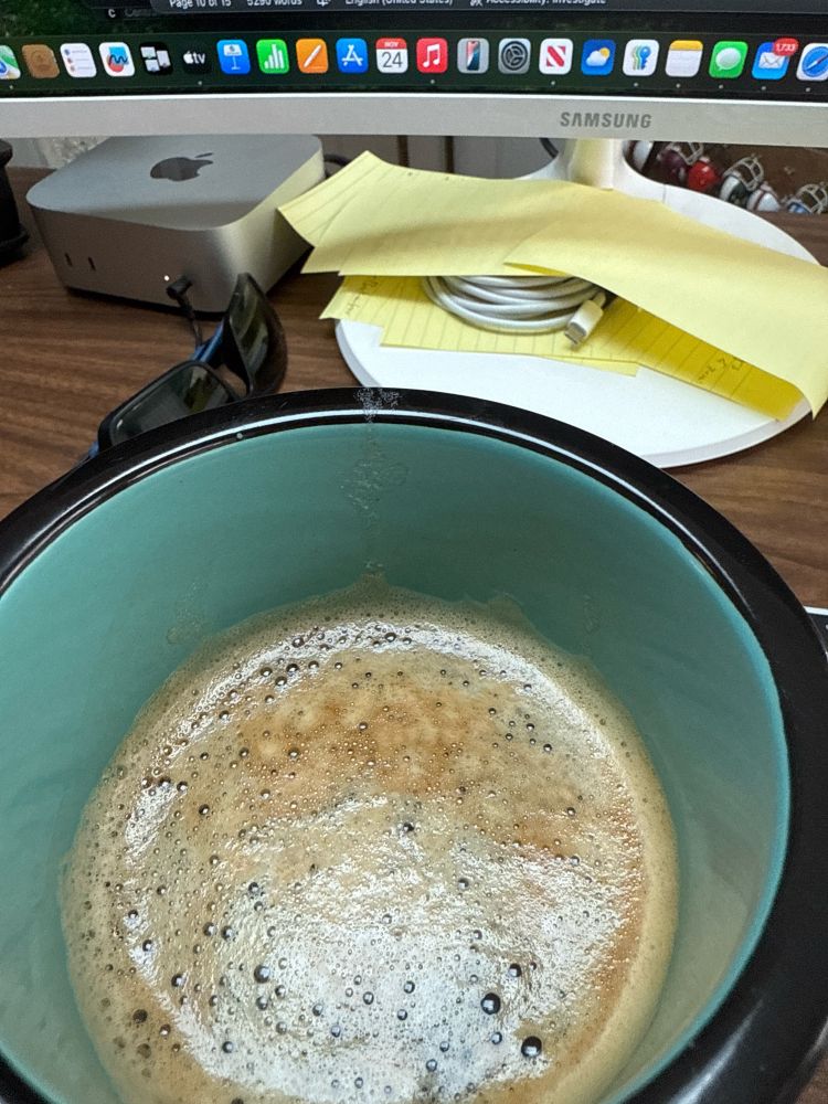 Mug of coffee pictured from above. 