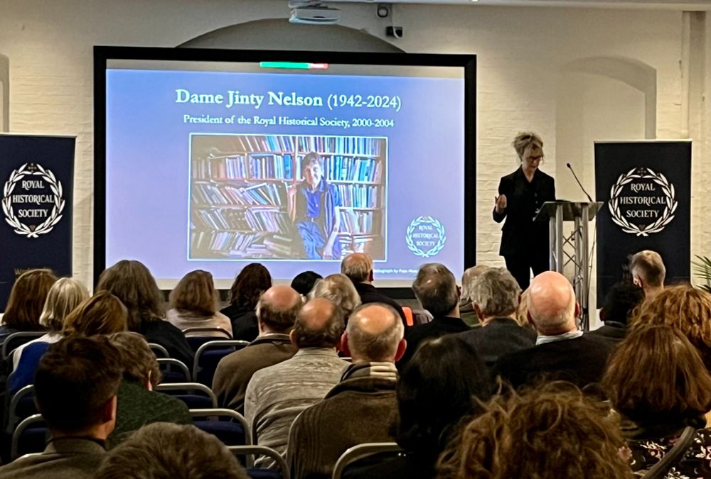 Professor Lucy Noakes, President of the Royal Historical Society, gives her Presidential Lecture on 22 November 2024 on taking up the Presidency of the Society. Lucy delivers her lecture before an image of Professor Jinty Nelson, a former President, who died in October and was remembered at the event.