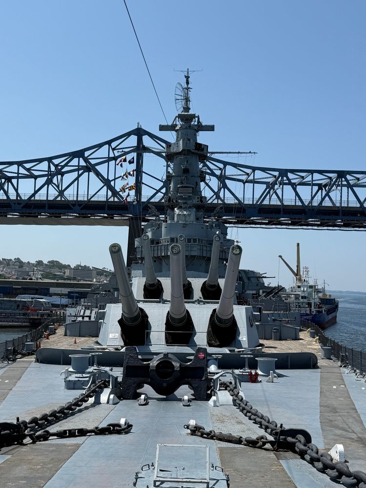 The superstructure and two 16-inch triple-mount gun turrets of the battleship USS Massachusetts, seen from the bow of the ship.