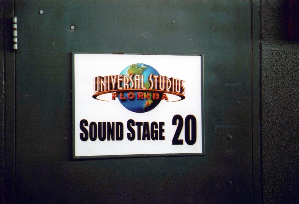 A black soundstage door with a white sigh. The top of the sign is the old Universal Studios Florida logo from 2002. Block letters beneath the logo read “Sound Stage 20.”