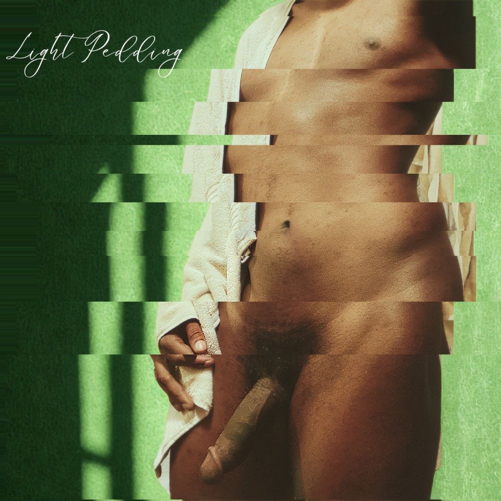 Light Pedding poses in front of an edited green background covered in of soft diffused light with their logo in white on the left most upper corner of the screen. The dark skinned model is nude and serving Gock. 