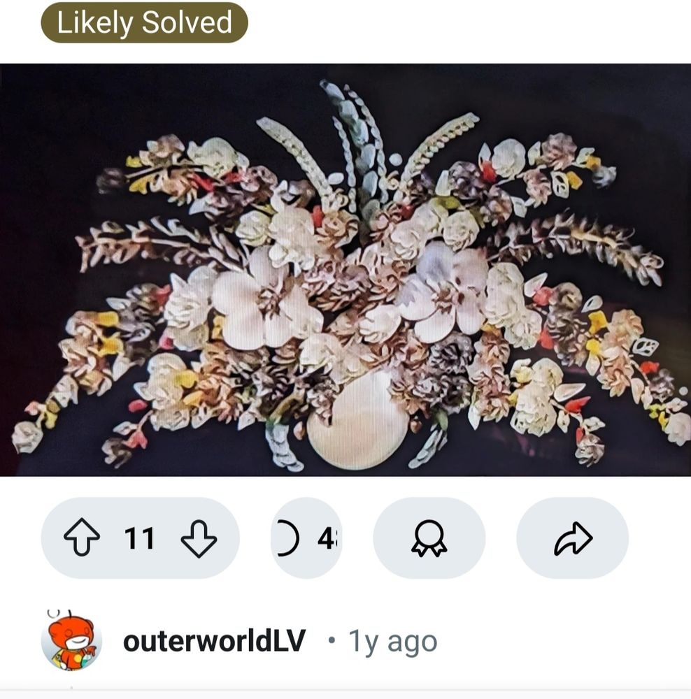 A vase bursting with detailed flowers has been created by artist Jose Meza using real shells!