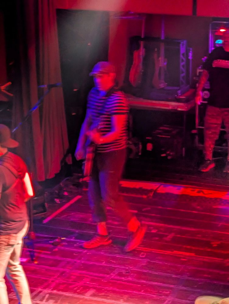 the band Streetlight Manifesto plays on stage. This image is of lead singer Toh Kay 