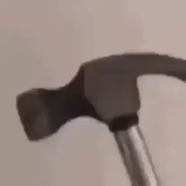 a blurry picture of a person holding a hammer .