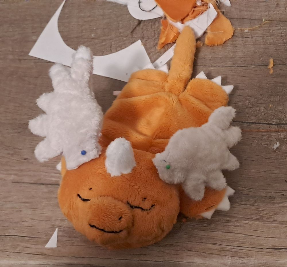 WIP of a mega Dragonite sleeping plush lying on my messy desk