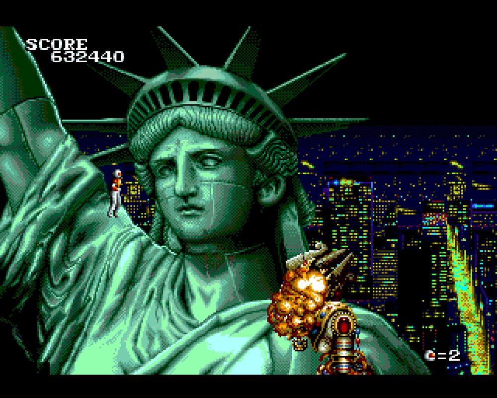 Chelnov standing atop the shoulder of the Statue of Liberty, having just vanquished the queen of the alien race of Destarians/Deathtarians, who were looking to take over the world. Her face is currently exploding as she is falling off the statue.