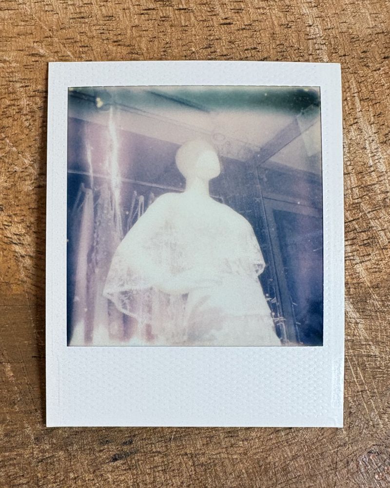 polaroid photograph of mannequin
