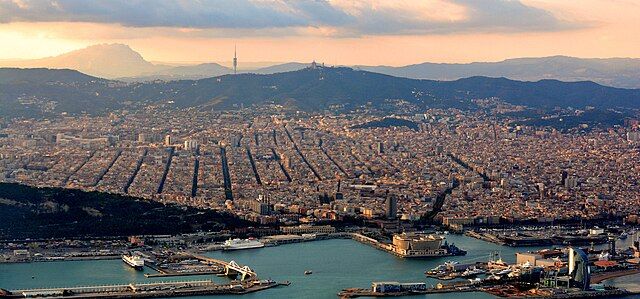An aerial panoramic photo of Barcelona in the evening.