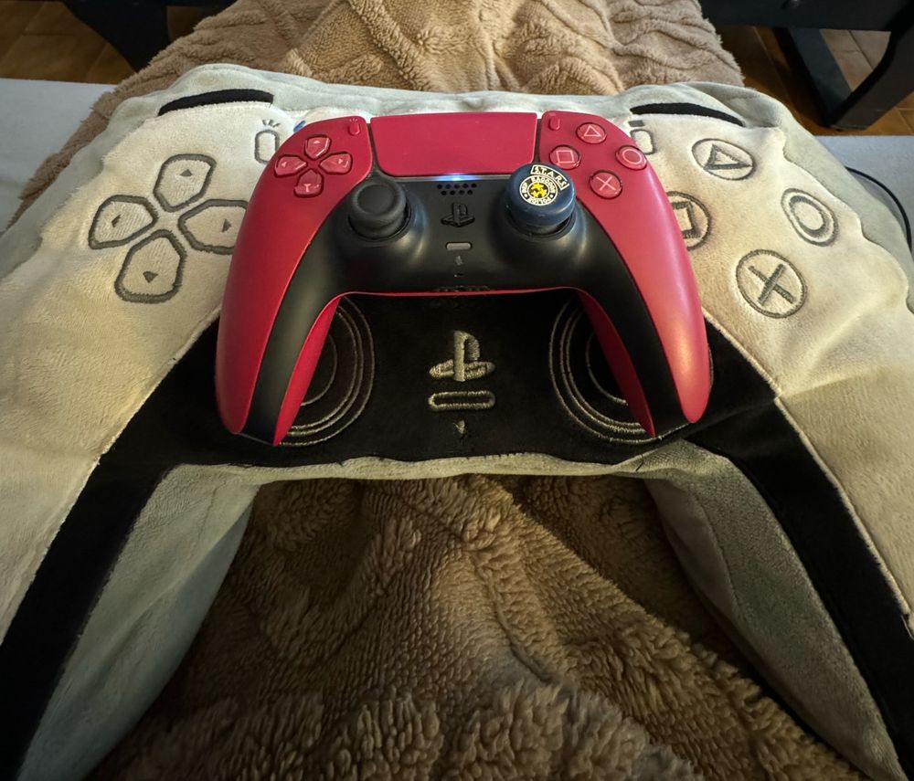 PS5 red controller on a PS5 controller cushion. 