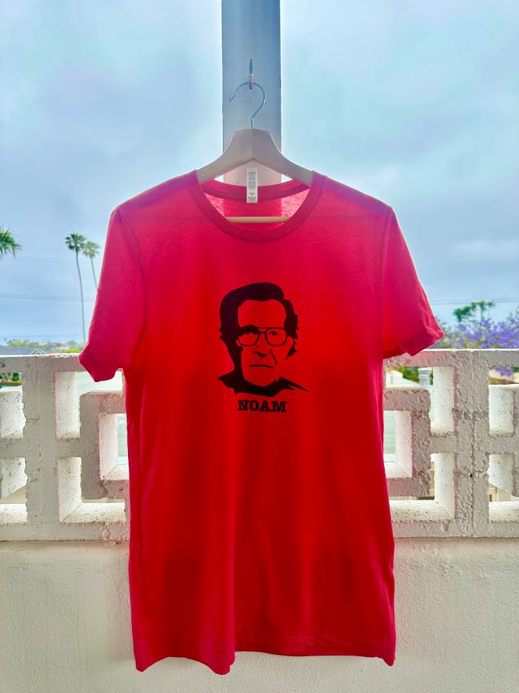Red tshirt with a black stencil design of Noam Chomsky in the style of the classic Che Guevara design.