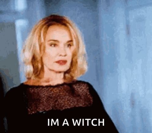 a woman is standing in a room and says i 'm a witch